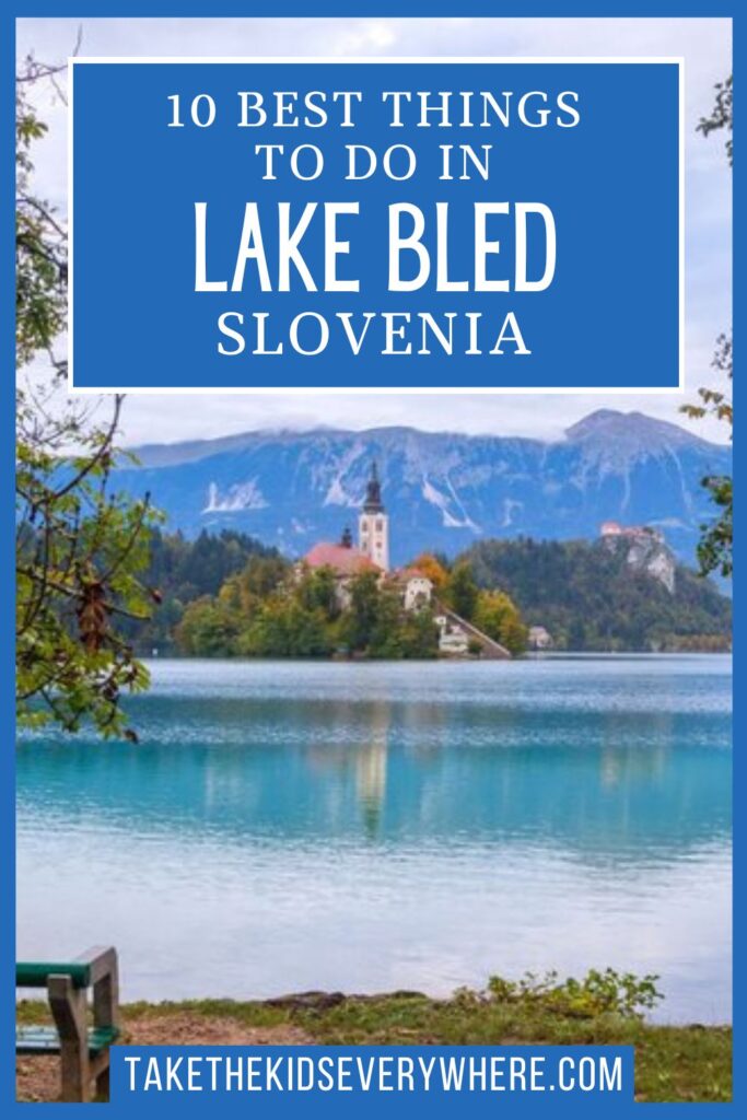 Lake Bled with its small island church reflected in calm blue water, framed by trees and backed by forested hills and mountains. Large blue text overlay reads "10 BEST THINGS TO DO IN LAKE BLED SLOVENIA" and a blue banner at the bottom reads "TAKETHEKIDSEVERYWHERE.COM".