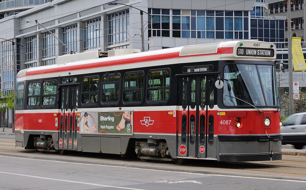 a red and white streetcar with the words "510 Union Station" on the front, on the street in Toronto Ontario