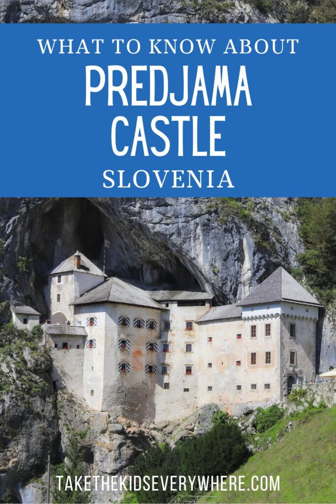 Vertical graphic featuring Predjama Castle built into the mouth of a dramatic cliffside cave in Slovenia. Text on the image reads "WHAT TO KNOW ABOUT PREDJAMA CASTLE SLOVENIA" and "TAKETHEKIDSEVERYWHERE.COM".