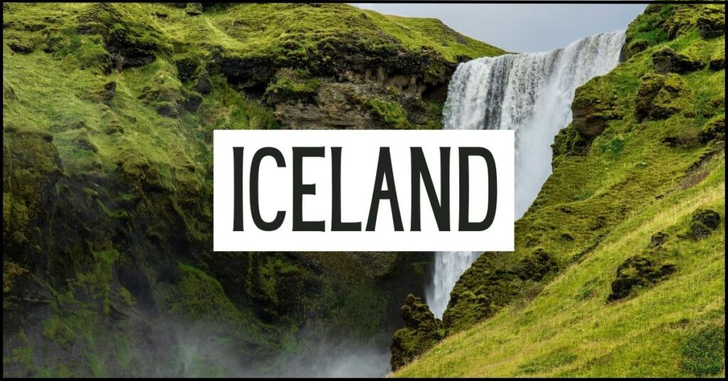 Powerful waterfall cascades between steep moss covered cliffs into a misty gorge surrounded by vivid green hills. Large white text overlay reads "ICELAND".