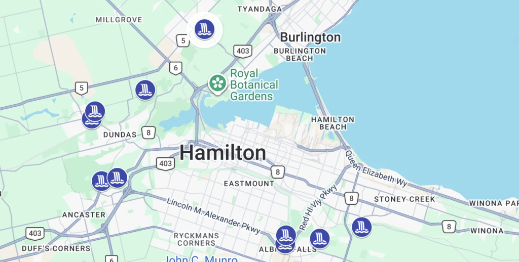 Map of Hamilton Ontario and surrounding areas with waterfall icons marking locations around Dundas Ancaster Stoney Creek and the Hamilton Mountain. Burlington and Royal Botanical Gardens are also shown for geographic context.