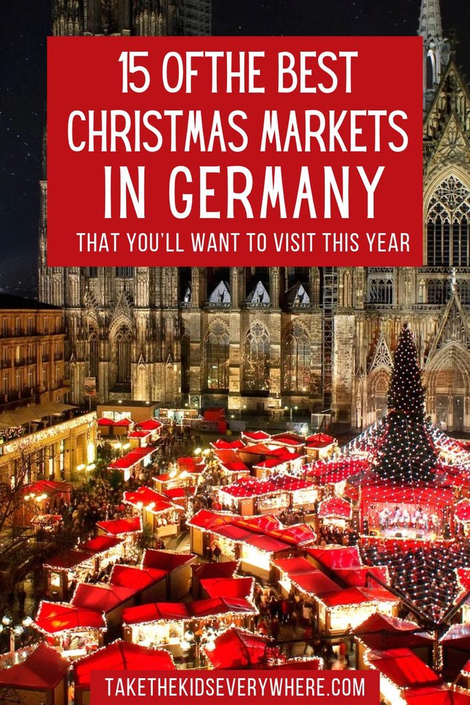 A brightly lit Christmas market fills a square in front of a large Gothic cathedral at night with red roofed stalls and a decorated Christmas tree. Text reads "15 OF THE BEST CHRISTMAS MARKETS IN GERMANY THAT YOU’LL WANT TO VISIT THIS YEAR" and "TAKETHEKIDSEVERYWHERE.COM".