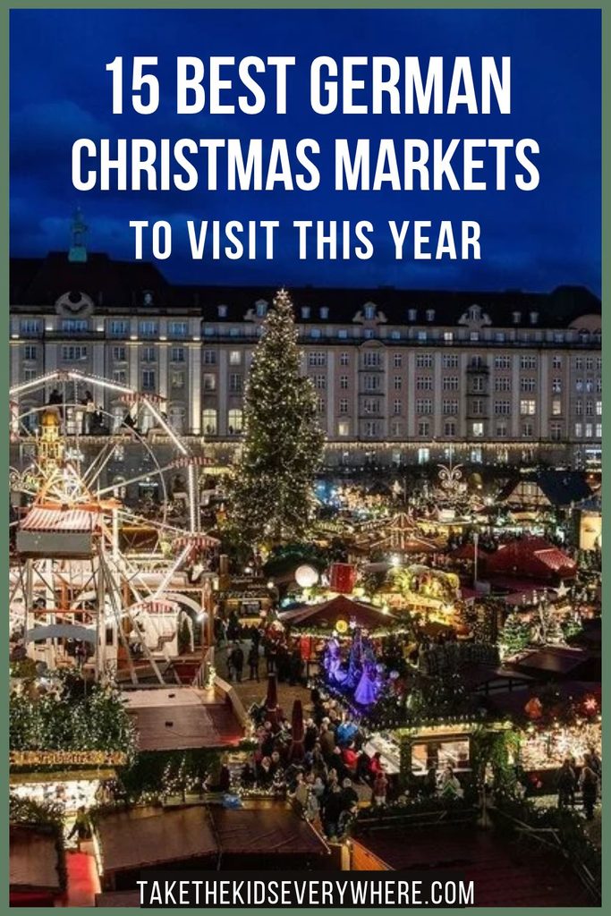 A crowded Christmas market at night with a large illuminated Christmas tree a Ferris wheel festive stalls and historic buildings surrounding the square. Text reads "15 BEST GERMAN CHRISTMAS MARKETS TO VISIT THIS YEAR" and "TAKETHEKIDSEVERYWHERE.COM".